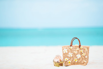 Beach accessories - straw bag, hat and unglasses on the beach
