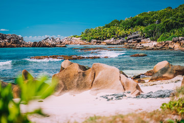 La Digue, Seychelles. Tropical exotic hidden paradise beach with granite boulders and coconut palm...