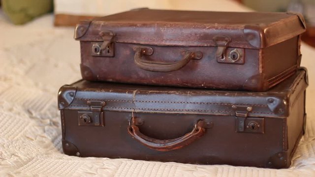 Vintage / Retro brown Suitcases - This old leather lugguage is stacked on top of each other. tracking Shot. Stock Video Clip Footage