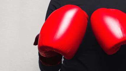 Hands in red boxing gloves close-up on a light background