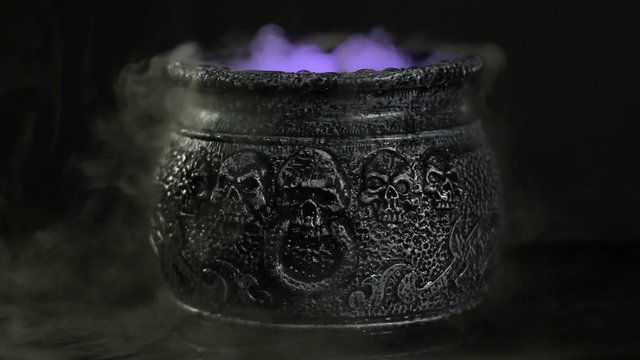 Bubbling black cauldron with smoke coming out. Boiling water with Dry Ice effect. Halloween. Stock Video Clip Footage