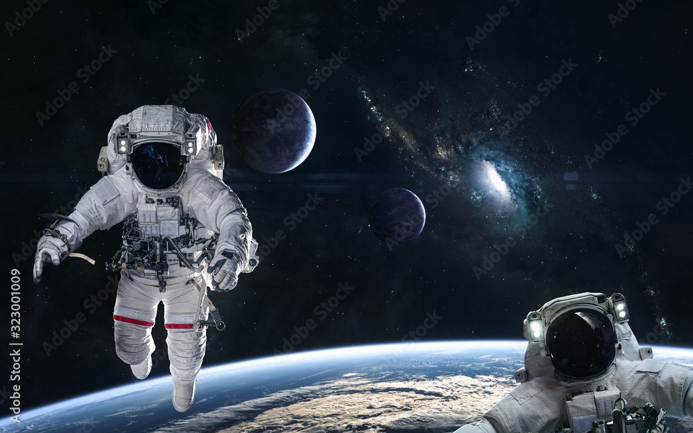 Wall mural astronauts in orbit of the planet on a background of blue spiral galaxy somewhere in deep space. sci