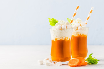 Carrot cake cocktail with whipped cream and marshmallow. Selective focus, copy space.