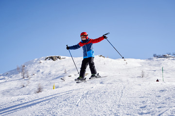 Crazy boy jumping on his skis in snow park