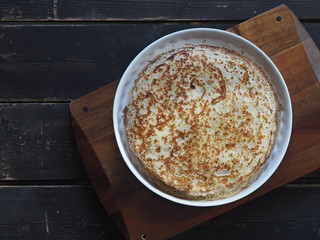 Spring, we meet Maslenitsa. Seeing off winter. Cooking pancakes on a gas stove. Next to the dough and ready-made pancakes.