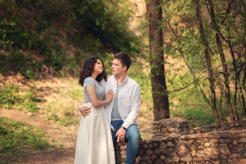 Young couple in love outdoor.Couple posing in summer in field.Smiling couple in love outdoors