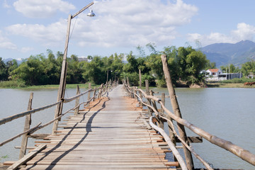 old wooden bridge over a small river