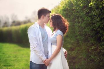 Fototapeta premium Young couple in love outdoor.Couple posing in summer in field.Smiling couple in love outdoors
