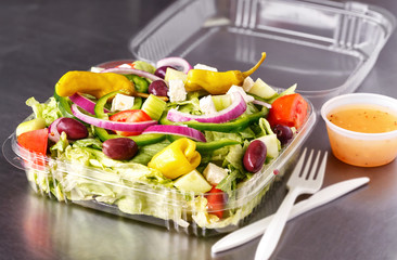 Carry out Greek salad in a plastic container