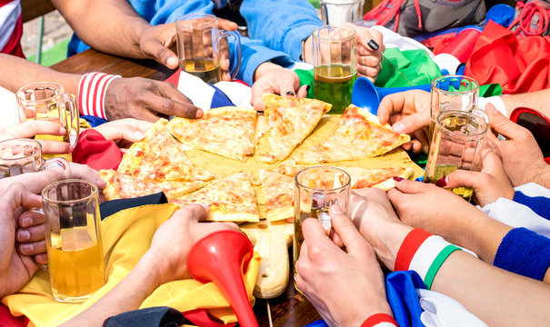 Top Side View Of Multiracial Hands Of Football Friends Supporter Sharing Pizza Margherita At Restaurant - Friendship Concept With Soccer Fan Enjoying Food Together - People Eating At Sport Bar Pub
