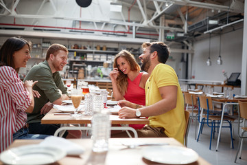 two couples having a good time in restauran. Lesiure, friendship concept