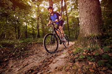 Fototapeta na wymiar Cyclist on a mountain bike riding in the forest .Spring, nature ,sport concept