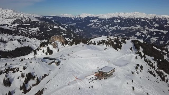 Aerial view of skiers on ski slopes in Penken area, Mayrhofen ski resort, Tyrol, Austria.