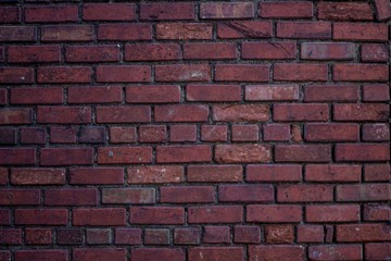 Dark aged red brick wall