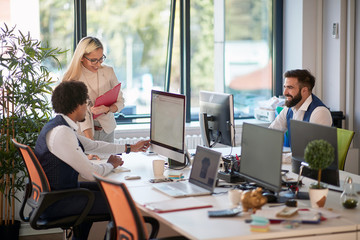 group of three colleagues in open space office. teamwork, success, modern business