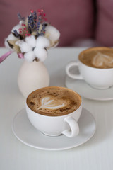 Food. Cup cappuccino coffee, wooden table