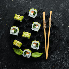 Japanese sushi -Green dragon. Avocado, onion, salmon and sushi cheese. Top view.