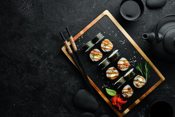 Sushi rolls of seafood - Okinawa. Eel fish, cheese, cucumber and Unagi sauce. Japanese traditional food