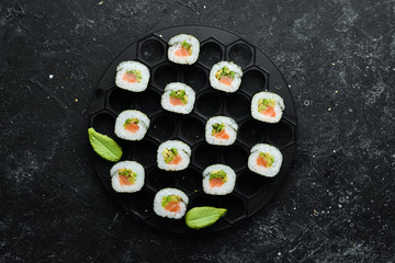 Sushi rolls with avocado and salmon. Classic Japanese sushi. Top view. Free space for your text.