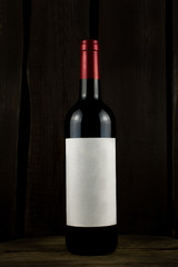 wine bottle and glass on wooden background