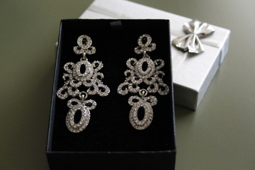 large decorative earrings in a box