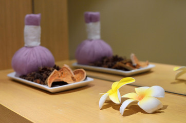 Plumeria flower on the table with blurred spa set on background