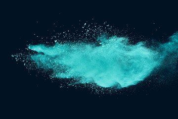 Blue sky color powder explosion on black background.