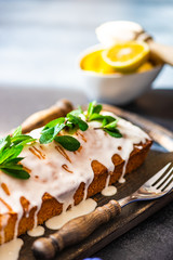 Tasty lemon cake with ingredients on stone background