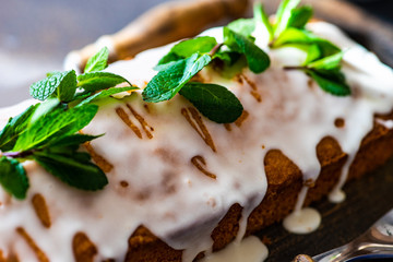 Tasty lemon cake with ingredients on stone background
