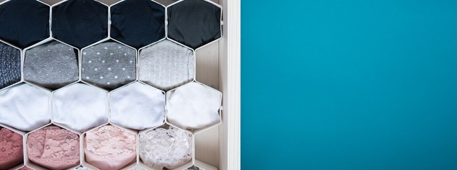 Panoramic shot of a honeycomb drawer organizer in the closet