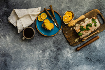 Tasty lemon cake with ingredients on stone background