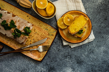 Tasty lemon cake with ingredients on stone background