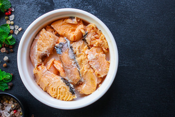 canned salmon, fish preserves (seafood in a tin can) menu concept background. top view. copy space