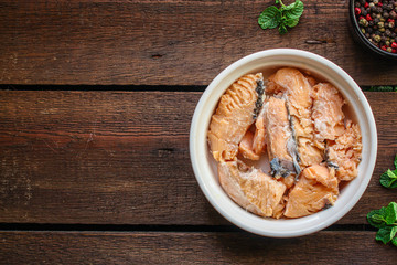 canned salmon, fish preserves (seafood in a tin can) menu concept background. top view. copy space