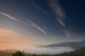 Twilight blue sky over a foggy valley in a morning