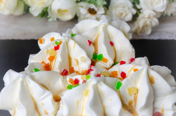 Ice cream ice cream sprinkled with colored pieces of fruit, quench thirst, cool. Macro close up