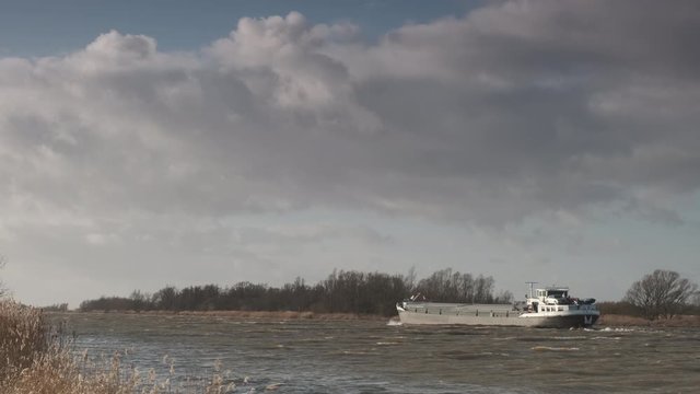 Ship sailing on the river IJssel during a windy day in Overijssel The Netherlands 
