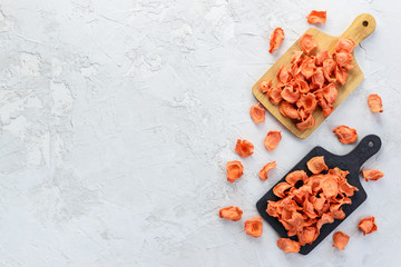 Carrot chips on the boards on a gray background. Horizontal orientation, top view, copy space.