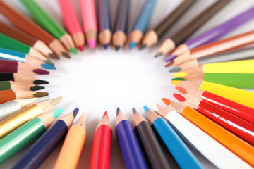 Colored pencils lie in a row