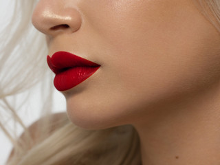 Sexual full lips. Natural gloss of lips and woman's skin. The mouth is closed. Increase in lips, cosmetology. red lipstick. Open mouth and with teeth. blonde hair.