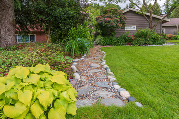 Entrance of a house with stone steps and outdoor landscape.