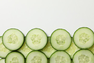 Cucumber slices on white background, space for text