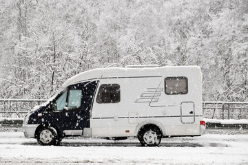 The motorhome. Camper. Rv. Winter. White snow. Rest in nature. Road. On the track. No people. 