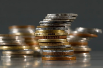 Group of various coins are stacked in piles