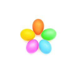 Five painted multi-colored chicken eggs are in the shape of a flower on a white background.