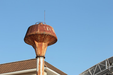 Water tower with blue sky background.