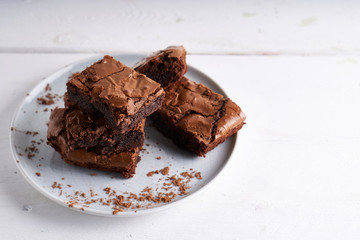 Pieces of brownie cake served on a white table Chocolate cake