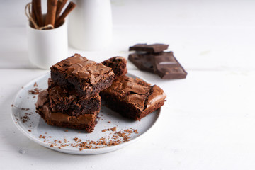 Pieces of brownie cake served on a white table Chocolate cake