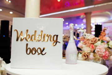 Naklejka na ściany i meble Box for money at the wedding. Newlyweds Money Box. White bottle of champagne. Style, fashion, details.
