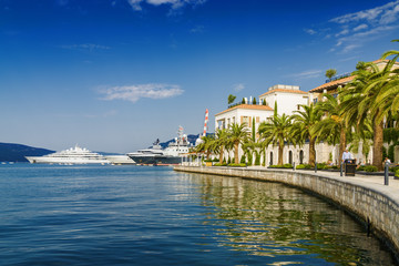 Beautiful embankment on the background of luxury yachts at the port of Tivat, Montenegro.